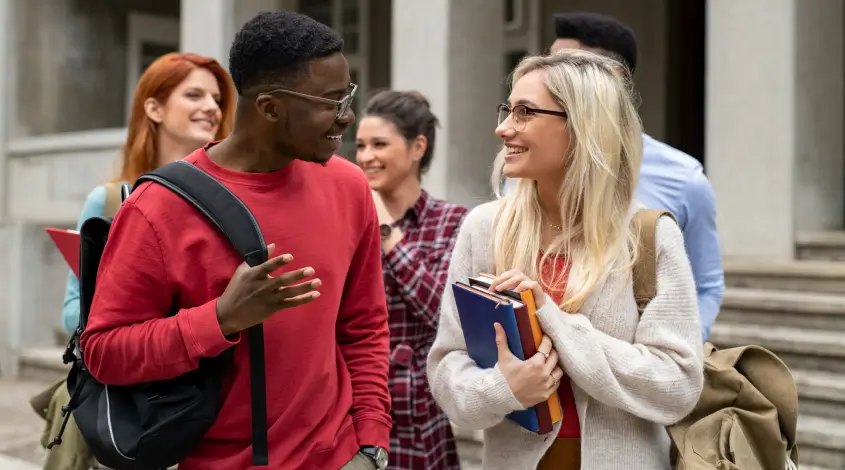 two students talking outside of a campus building