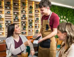 a waiter processing a woman's order